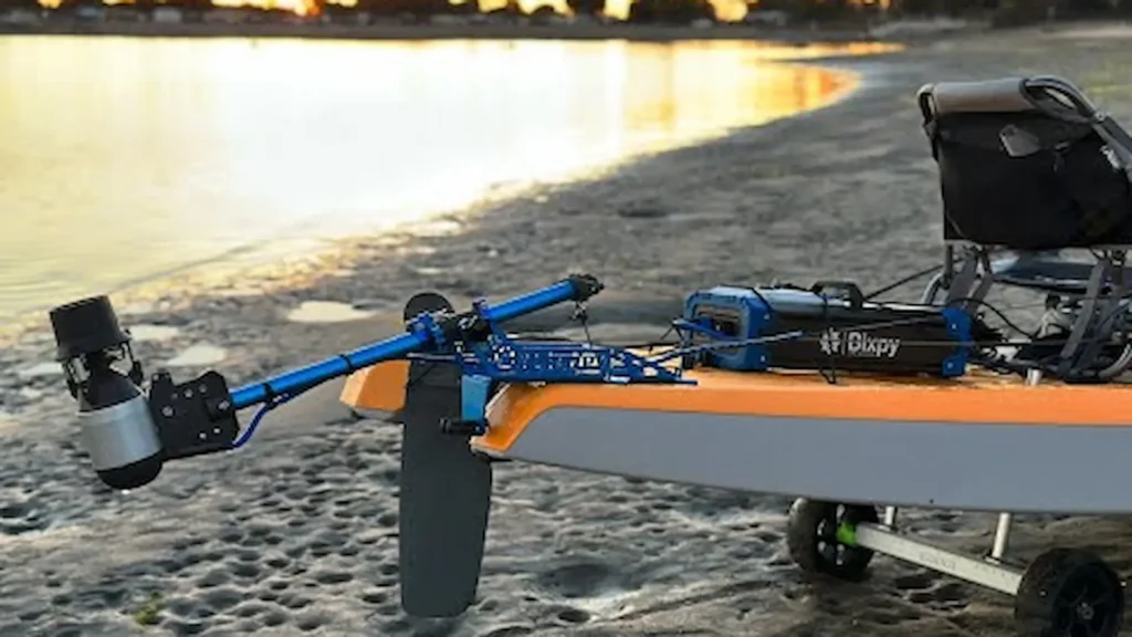 Bixpy K-1 motor mounted on a kayak parked on the shoreline at sunset