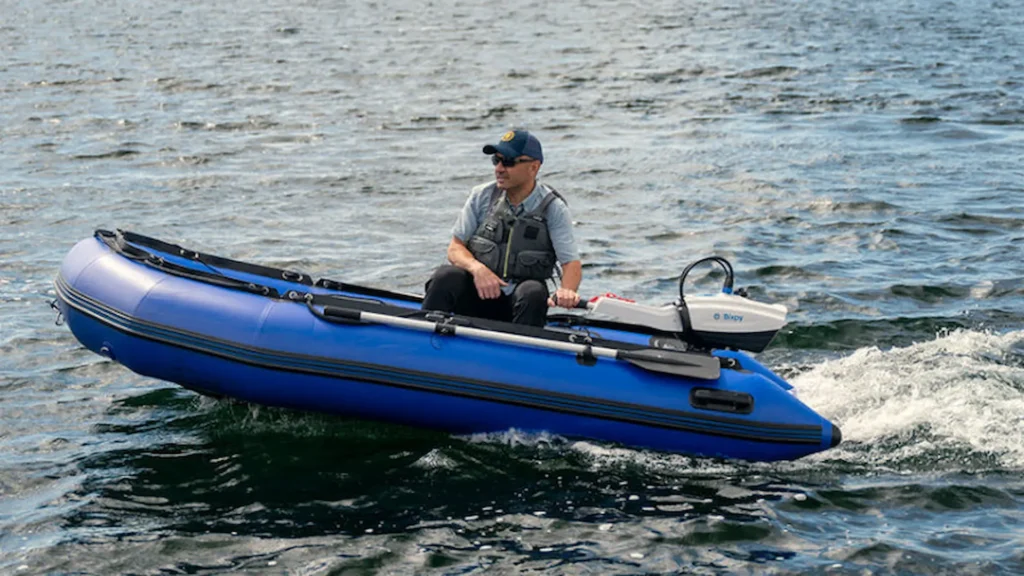 Blue inflatable boat powered by a Bixpy N-3 outboard motor cruising on the water