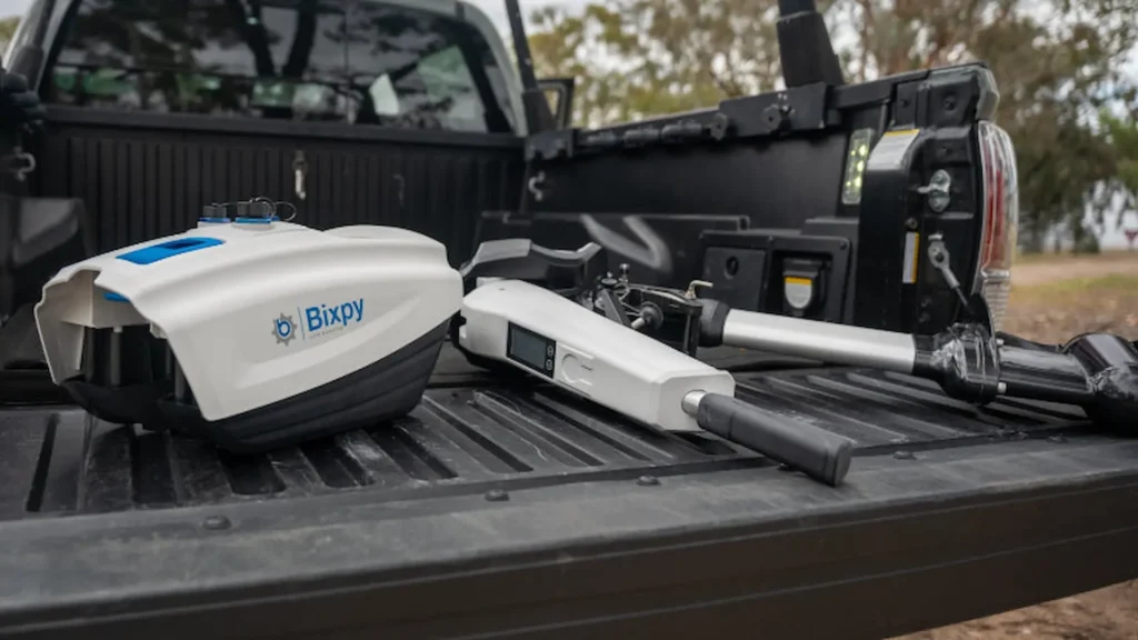 Bixpy N-3 outboard motor and accessories placed in the bed of a pickup truck