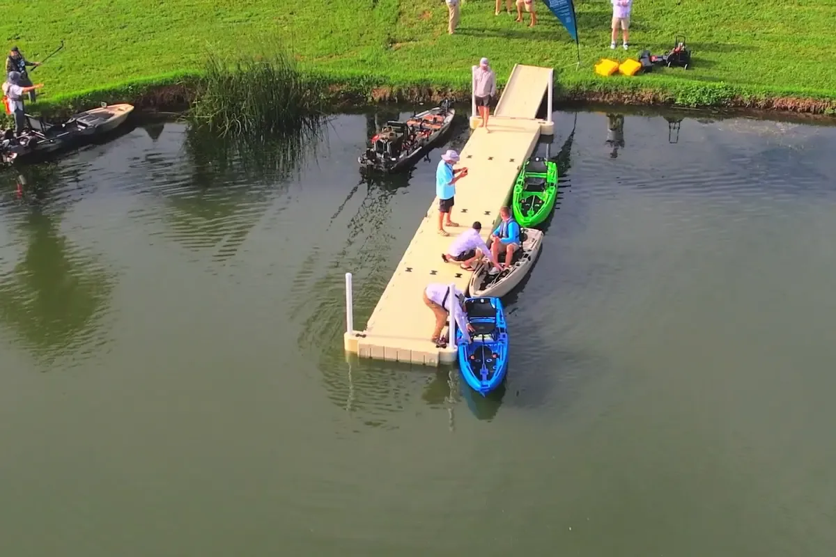 FluxJet electric jet fishing kayak launching beside a dock, viewed from above