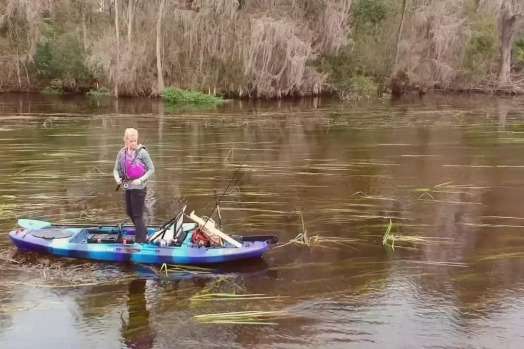 Vibe Sea Ghost 105 WRD First Look: A Compact Fishing Kayak Built for Power 6 Angler standing and fishing from a stable Vibe Sea Ghost kayak