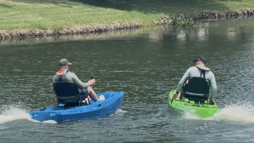 Two anglers riding FluxJet electric kayaks away from shore
