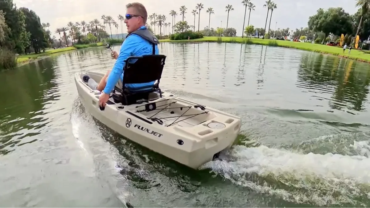 FluxJet Kayak Review: Weed-Ready Electric Jet Power Without an Exposed Prop 5 Angler cruising across a calm lake in a FluxJet electric kayak