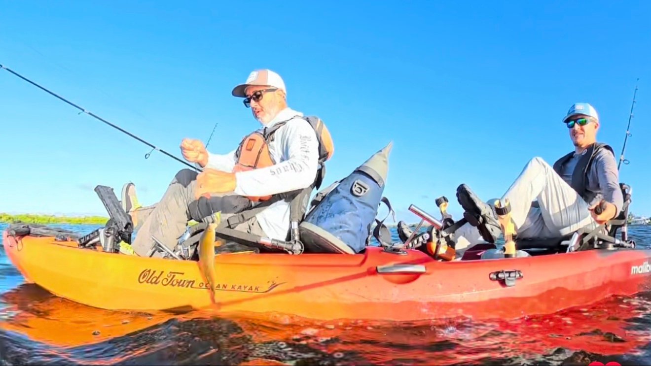 Two people pedaling the Old Town Malibu Pedal T tandem kayak during a sunset on-water test.