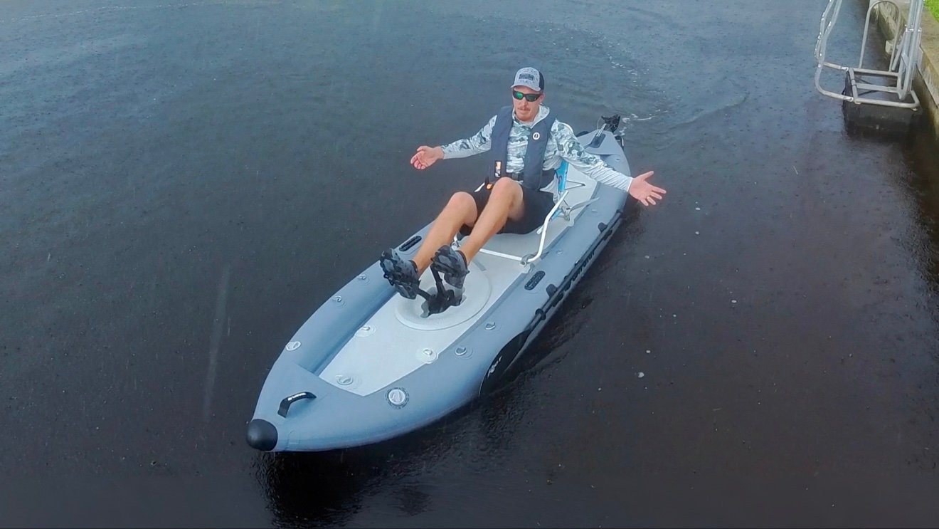 Saturn FPK365 inflatable pedal kayak being paddled on a residential canal during an on-water test.